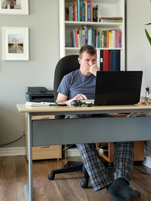 Man Working at Desk in his Pajamas